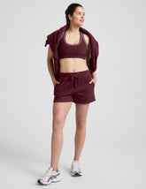 red mid rise sweat shorts with a 3.5" inseam and pockets.